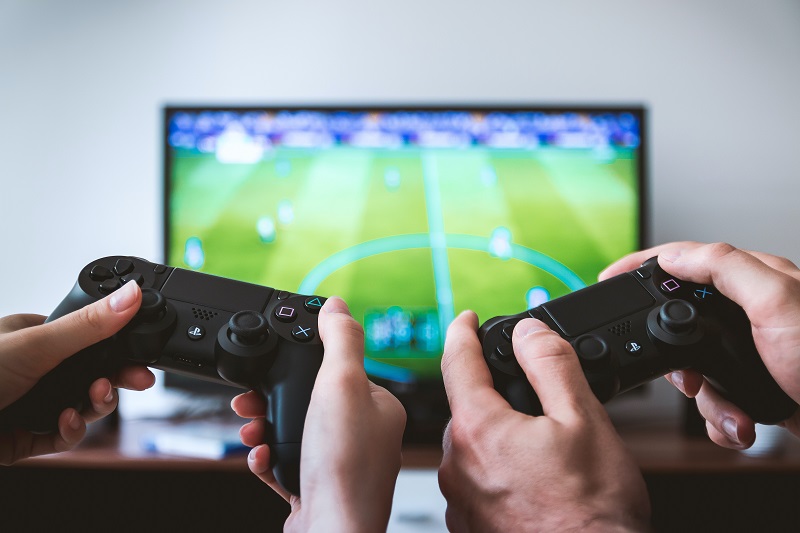 Two people playing soccer video game