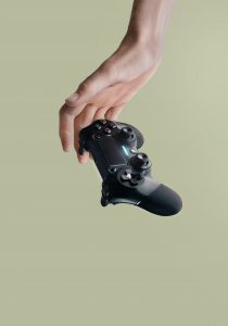 hand dropping black PlayStation Controller